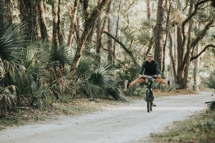 a person riding a bike down a dirt road