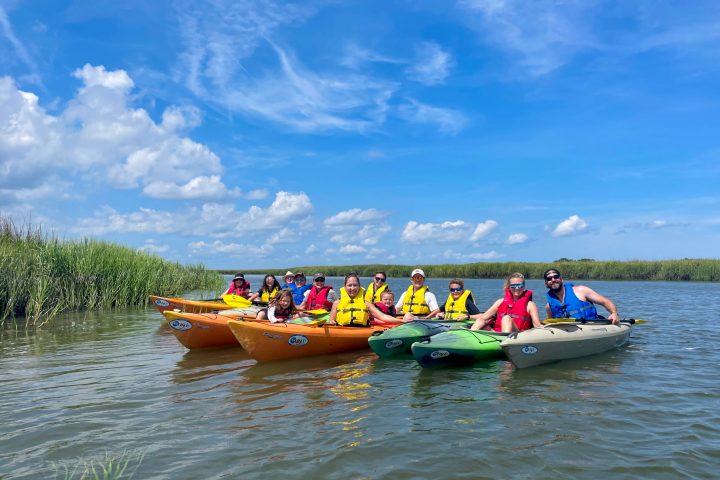 a group of people in a small boat in a body of water