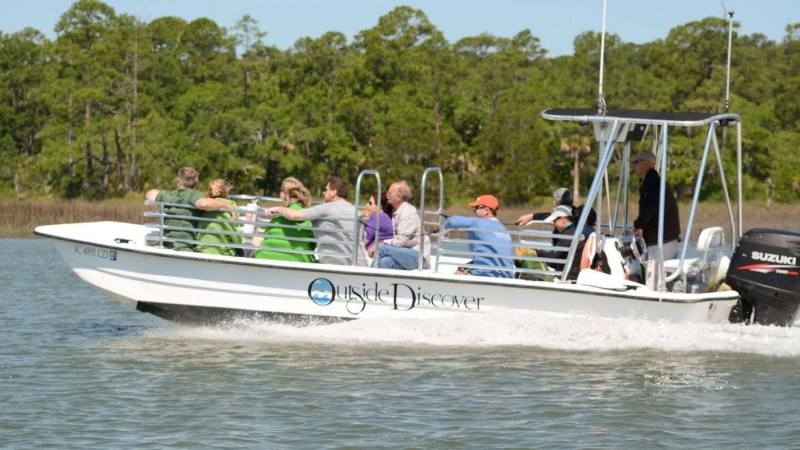 a group of people riding on the back of a boat