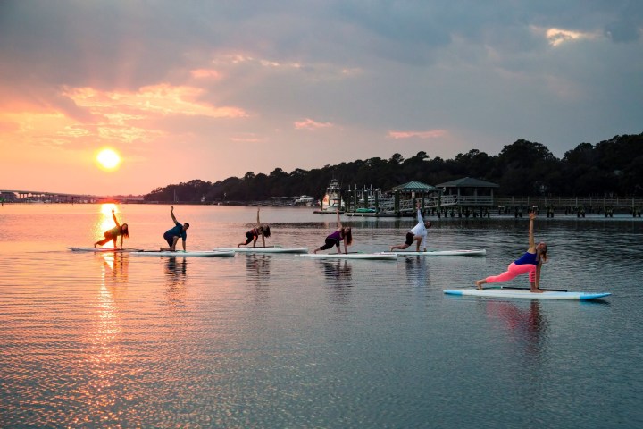 a group of people rowing a boat in the water